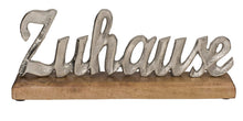 Silberner Metall-Schriftzug "Zuhause" auf Holz-Standfuß